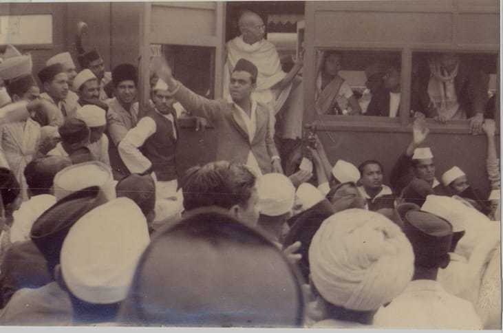 Mahatma Gandhi in a train with crowd. Before 1942.
