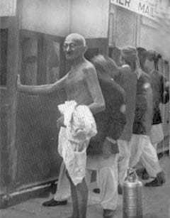 Gandhi just before entering a train, October 1937.