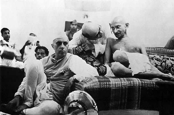 Mahatma Gandhi sitting next to Jawaharlal Nehru at the AICC General Session, 1942.