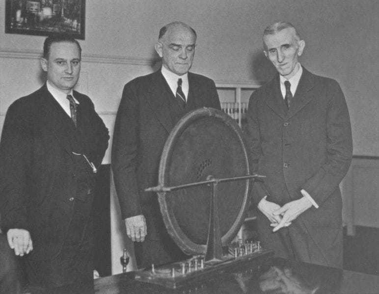 Photo three of three. John T. Morris, Victor Beam and Tesla pose with the alternator that had been discovered.