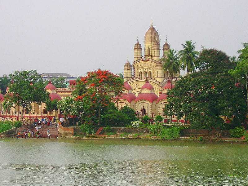 The DAKHSHINESWAR TEMPLE was founded by RANI (Queen) of Janbaazar RASHMONI in 1855 on the east bank of the Ganges river. The main temple is of NABARATNA (with 9 spires) style. It houses a KALI idol standing on the chest of a lying SHIVA. The two idols are placed on a thousand-petaled lotus made of silver. Besides the main temple, there are 12 smaller SHIVA temples & a Temple dedicated to LAXMI-NARAYANA. This is a major place of pilgrimage in West Bengal, especially for the followers of SRI RAMAKRISHNA DEVA.
