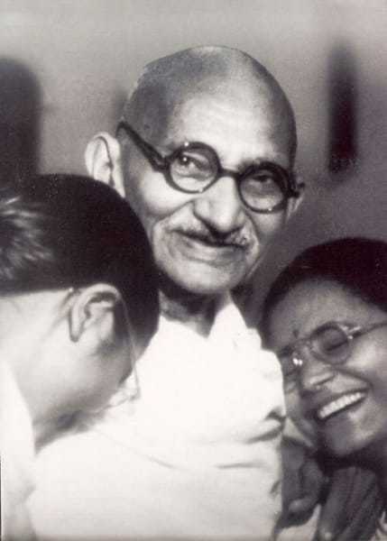 Mahatma Gandhi with his grand daughter Manu (left) and the wife of his grand nephew Kanu Gandhi, Abha, at Birla House, New Delhi, in December 1947.
