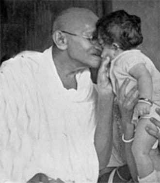 Mahatma Gandhi with a child, Poona. September 1945.
