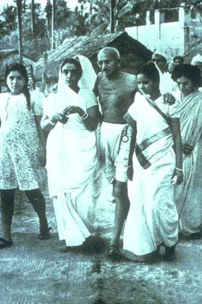 Mahatma Gandhi with his hostess, Sumati Morarjee at Juhu Beach, Bombay, May/June 1944.