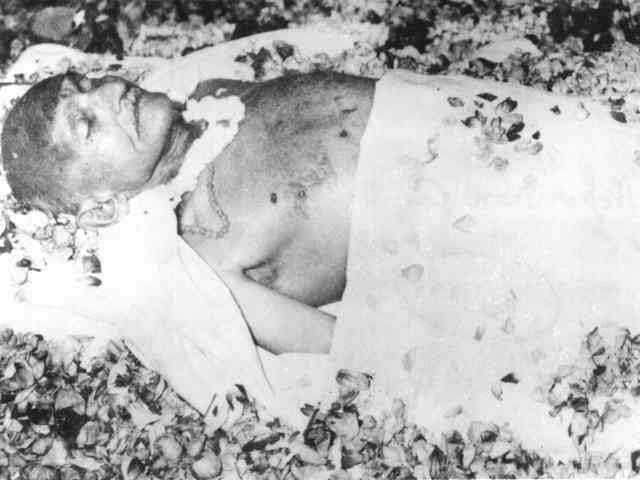 Gandhi on the deathbed, covered with flowers. January 31, 1948.