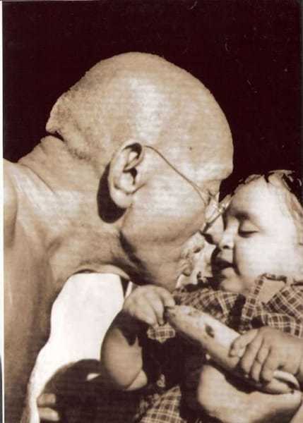 Mahatma Gandhi presenting a birthday present to Nandini, niece of Gandhi's secretary Pyarelal Nayer, at Sevagram Ashram, August 1944.
